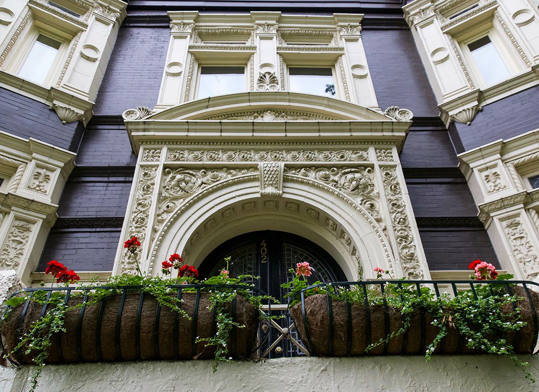 About Our Agency - Closeup View of a Historical Building in Downtown Louisville Kentucky with Decorative Window Frames and Flower Planters